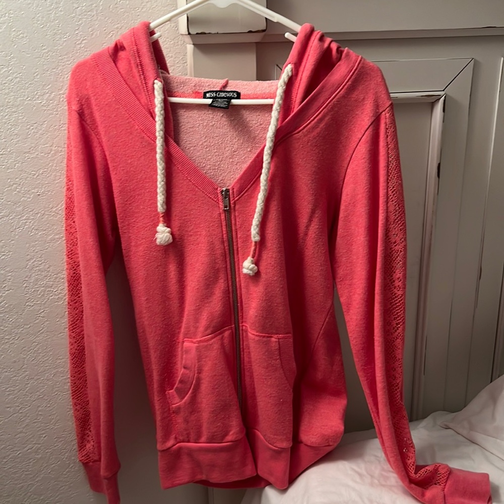Zip up hooded jacket. Size large. Form fitting. Lace cut out sleeves.